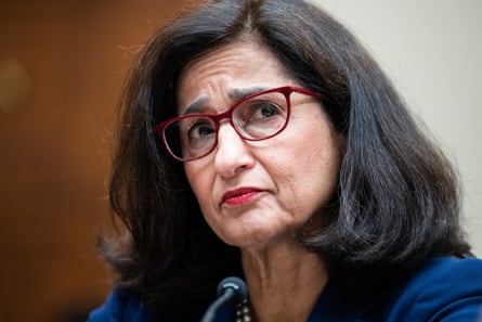 a woman with dark hair and glasses