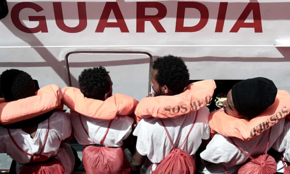 Rescued migrants on an Italian coastguard boat following their rescue from the NGO rescue ship Aquarius.