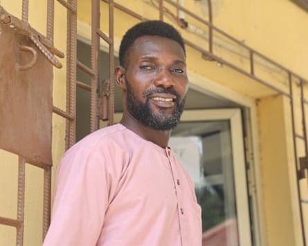 A man stands in front of a door
