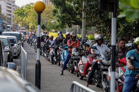 People queue to buy fuel at a gas station in Colombo, Sri Lanka.