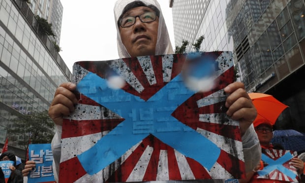 South Korean protesters hold Japanese rising sun flags during a rally to mark the South Korean Liberation Day from Japanese colonial rule in August.
