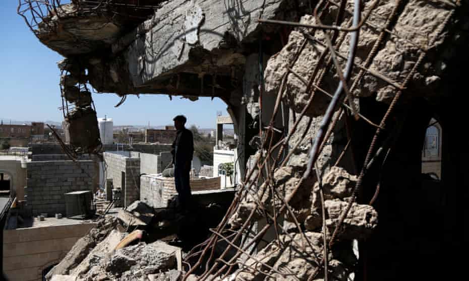 A Yemeni man inspects a house destroyed in an airstrike carried out during the war by the Saudi-led coalition’s warplanes.