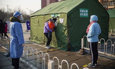 Residents wait in line for nucleic acid test at a COVID-19 testing site in Daxing District of Beijing, China, January 20, 2021.