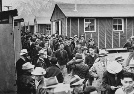 masses walking between small buildings