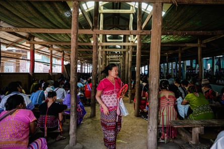 Karen refugees in a temporary wooden shelter gathering for a Sunday service. Most Karen refugees are Christian.