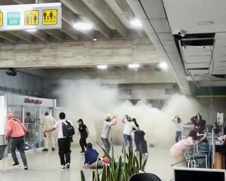 People react as dust rises through a terminal building