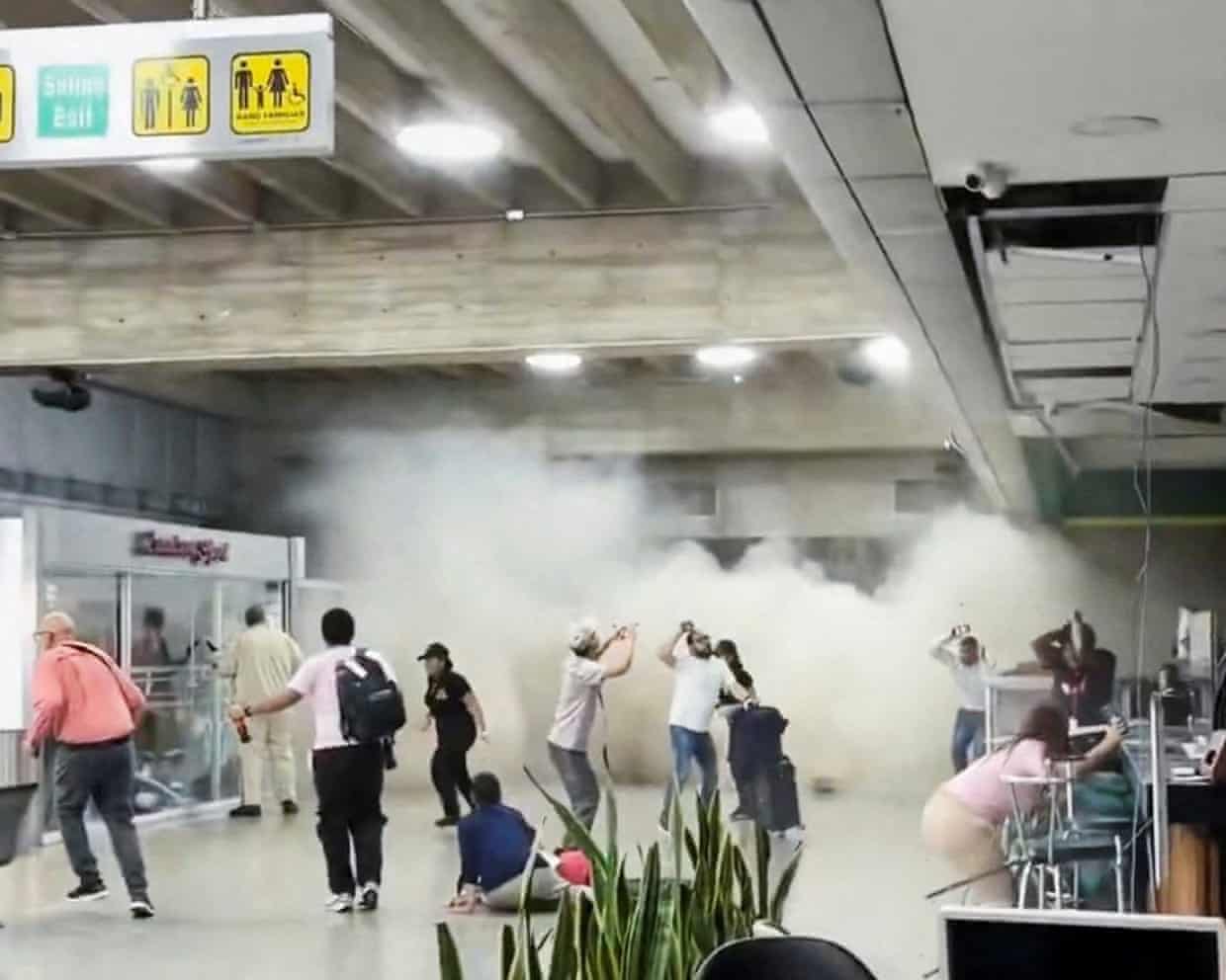 People react as dust rises through a terminal building