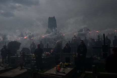 Mourners light flares during a funeral ceremony in Przemysl, Poland, on Saturday, for Damian Soból an aid worker killed in an Israeli strike in Gaza.
