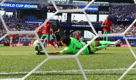 France's Ousmane Dembele scores their second goal past Morocco's Yassine Bounou