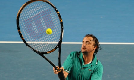 Henri Leconte plays with an oversized racket in a legends doubles exhibition match
