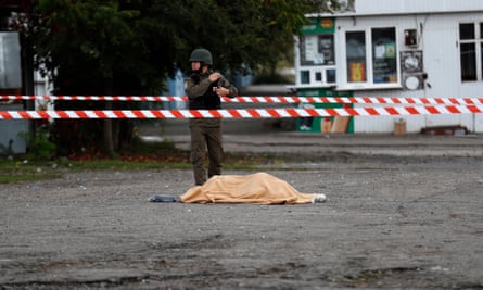 The body of one of the victims is covered with a blanket