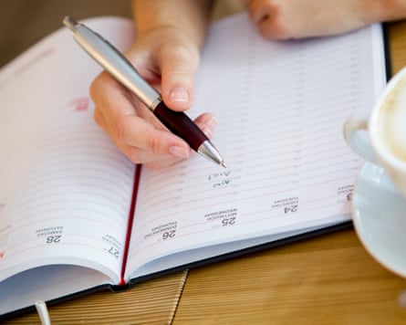 Close up of woman writing in planner