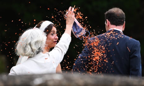 A woman throws confetti as former chancellor George Osborne and his wife Thea Rogers after their wedding at St Mary's Church in Bruton, Somerset on Saturday.