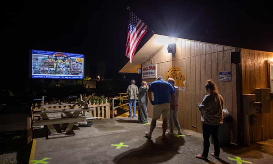 People wait in the socially distanced line for the snack bar during the intermission of a double feature movie at the Tiger Drive-In theater in the tiny mountain town of Tiger, Georgia, last Friday.