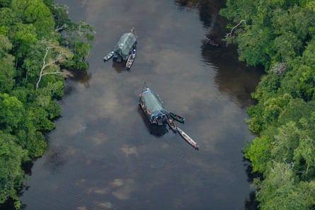Viewed from above, two dredging rafts operated by illegal miners on the Nanay River in Loreto, Peru.