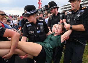 An Animal Rebellion activist is arrested after running onto the racecourse