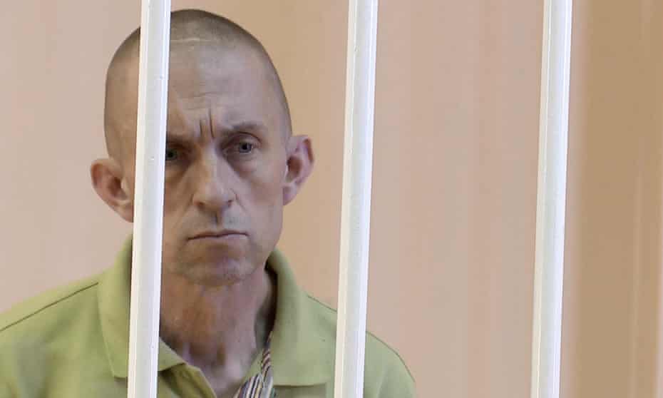 A still image shows Briton Shaun Pinner in a courtroom cage at a location given as Donetsk.