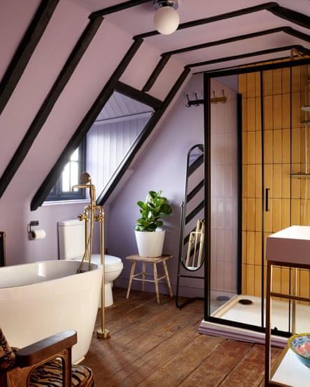 Lavender walls and saffron tiles form a striking contrast to the original black beams.