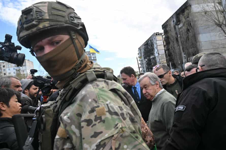 A guard separates Guterres from the media in Borodianka.