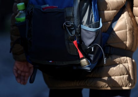 Bear bell hung on backpack of walker