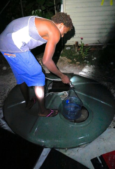 A detainee gets water from a makeshift well inside the Manus Island detention centre.