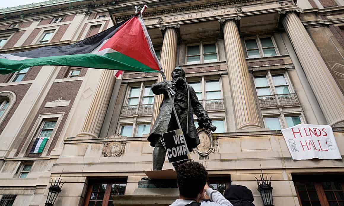 A student protester waves a Palestinian flag at Columbia University in New York City on 30 April 2024.