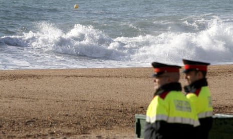 Police officers guard a beach in Lloret de Mar, Spain.