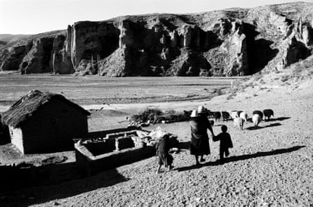 A family walks across the altiplano at Estancia Arco, in Bolivar province