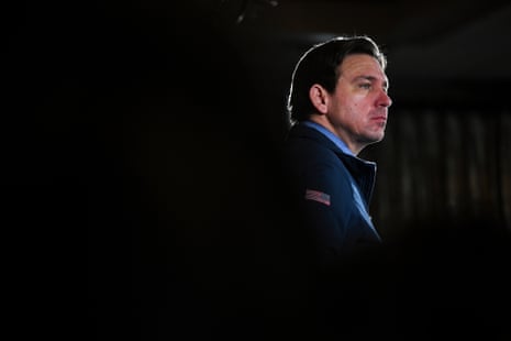 Ron DeSantis in profile against shadowy background