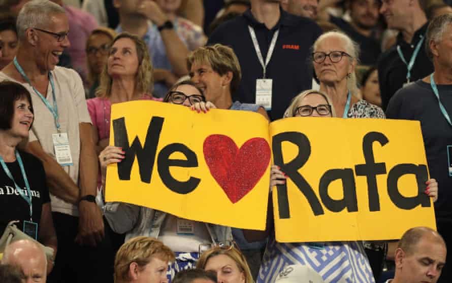 Spectators hold up banners of support for Rafael Nada