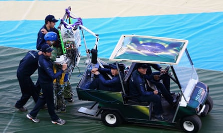 Juan Pinto in an exoskeleton is helped onto the field during the Opening Ceremony of the 2014 FIFA World Cup Brazil.