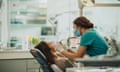 A woman has her teeth checked during a dental appointment.