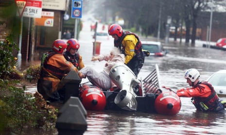 Fire and rescue services evacuate a woman from her flooded home in Littleborough, Greater Manchester
