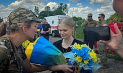 Ukrainian police officer Maryana Checheliuk, 24, from Mariupol, tearfully holds flowers after she was returned from two years in Russian captivity as part of a prisoner exchange