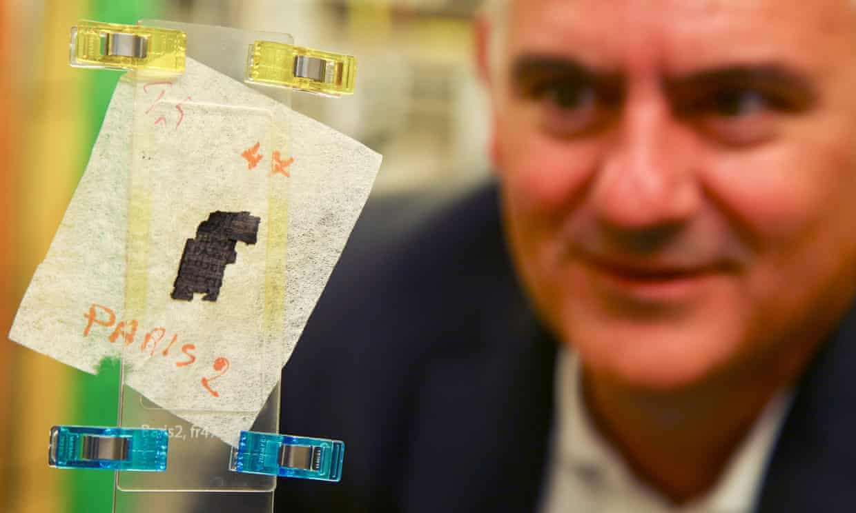 Brent Seales, director of the digital restoration initiative at the University of Kentucky, examines a piece of Herculaneum scroll. Photograph: Geoff Caddick/AFP/Getty Images