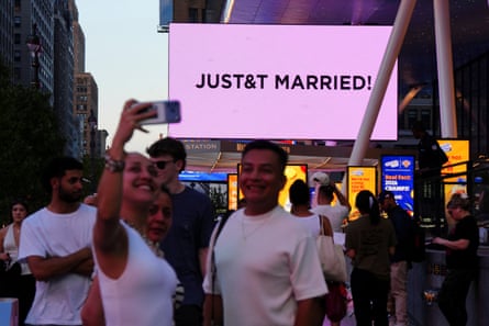 People take selfies outside Madison Square Garden, the venue for Taylor Swift and Travis Kelce’s wedding.