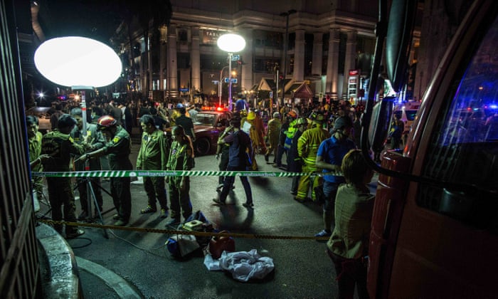 Emergency personnel and investigators gather after a deadly explosion hits central Bangkok