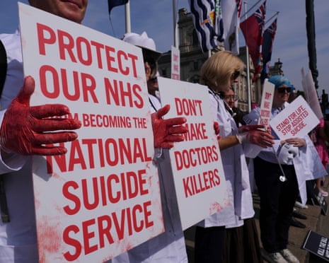 Demonstrators against assisted dying hold banners outside parliament in London on Friday.