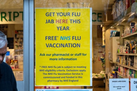A sign encouraging people to get their flu jab in the window of a pharmacy in Langley, Berkshire on 12 December 2025.