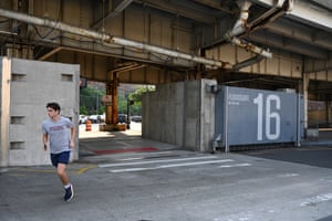 Man jogging under bridge