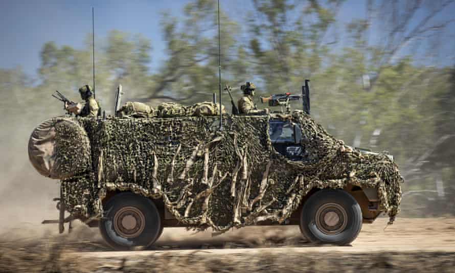 An Australian Army Bushmaster armoured vehicle moves off road during a training mission.
