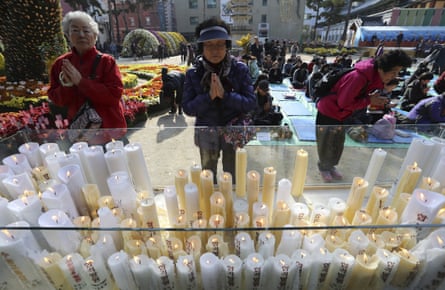 Women pray during a special service to wish their family members success in the college entrance exams at the Jogye temple in Seoul, South Korea.