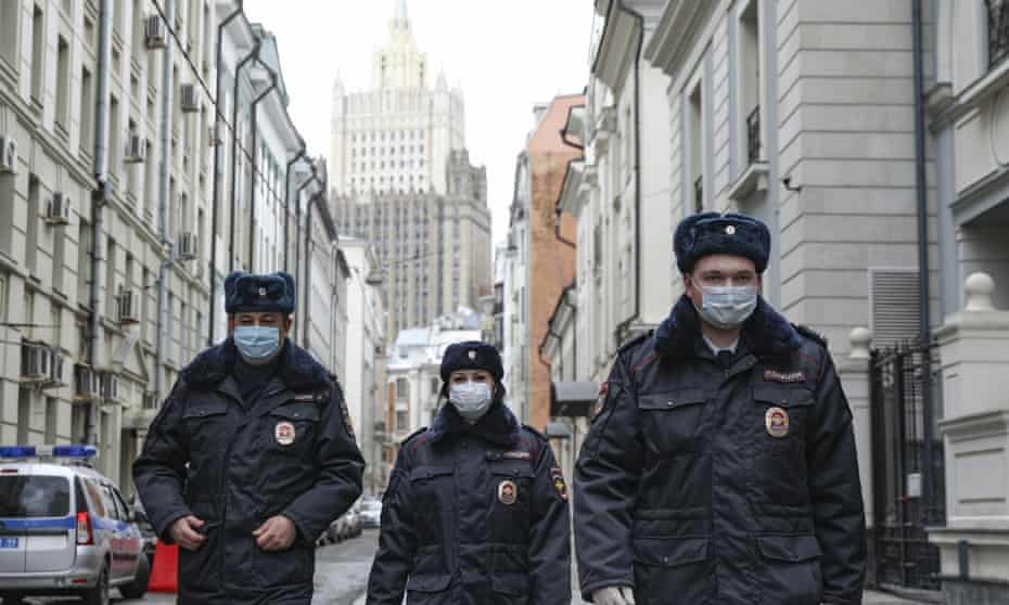 Russian police officers patrol an almost empty Arbat street in Moscow on Thursday.