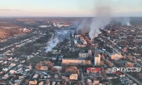 Aerial view of smoke rising from buildings in an urban area