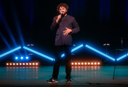 Nish Kumar live on stage.