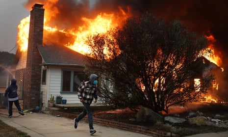 California wildfires: deadly blazes continue to grow as officials warn of shortage of firefighters – latest updates People attempt to save a neighboring home from catching fire during the Eaton Fire on January 8, 2025 in Altadena, California.