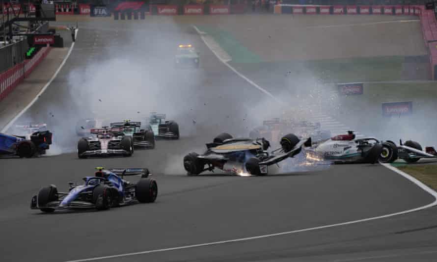 Cars crash at the start of the British Formula One Grand Prix .