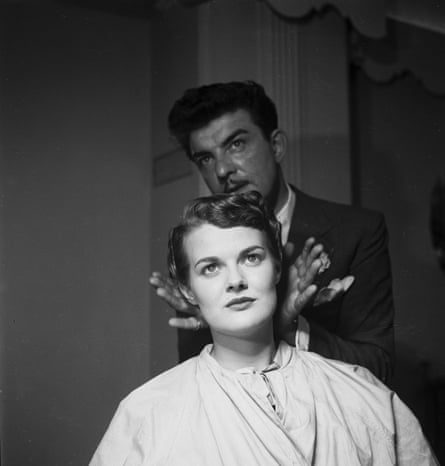 Raymond, ‘Mr Teasy Weasy’ admires a hairstyle he has created, 1952.