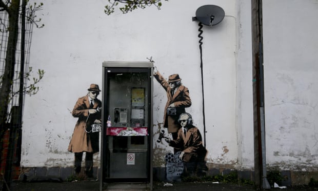 Street art showing surveillance of phone box in Cheltenham, England