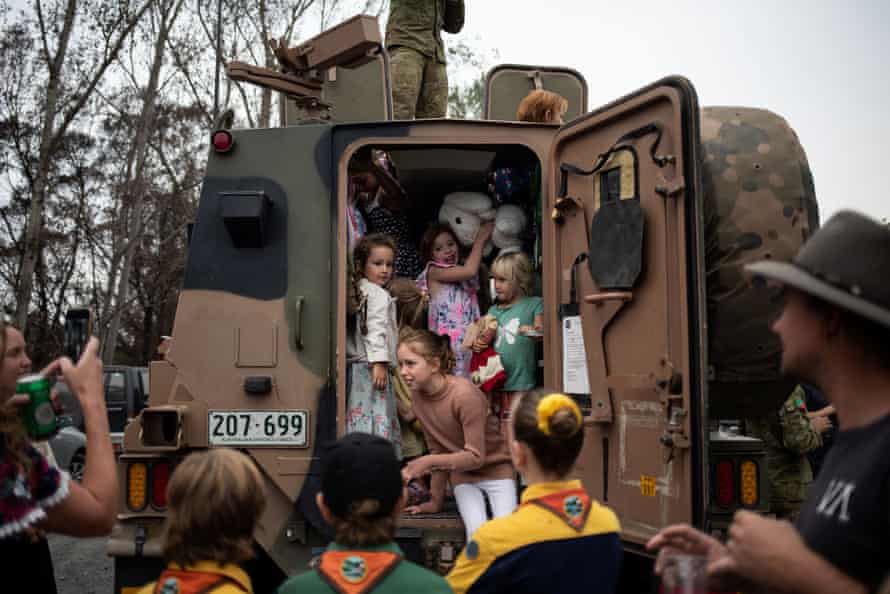 Children play inside an Australian Army forces vehicle helping with bushfire recovery in Cobargo, NSW on 12 January 2020.